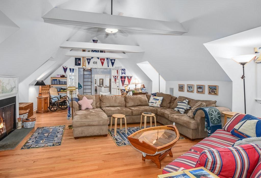 123 Long Neck Point Road Darien, CT 06820 - Photo 31 of 41 a living room with lots of furniture and a chandelier