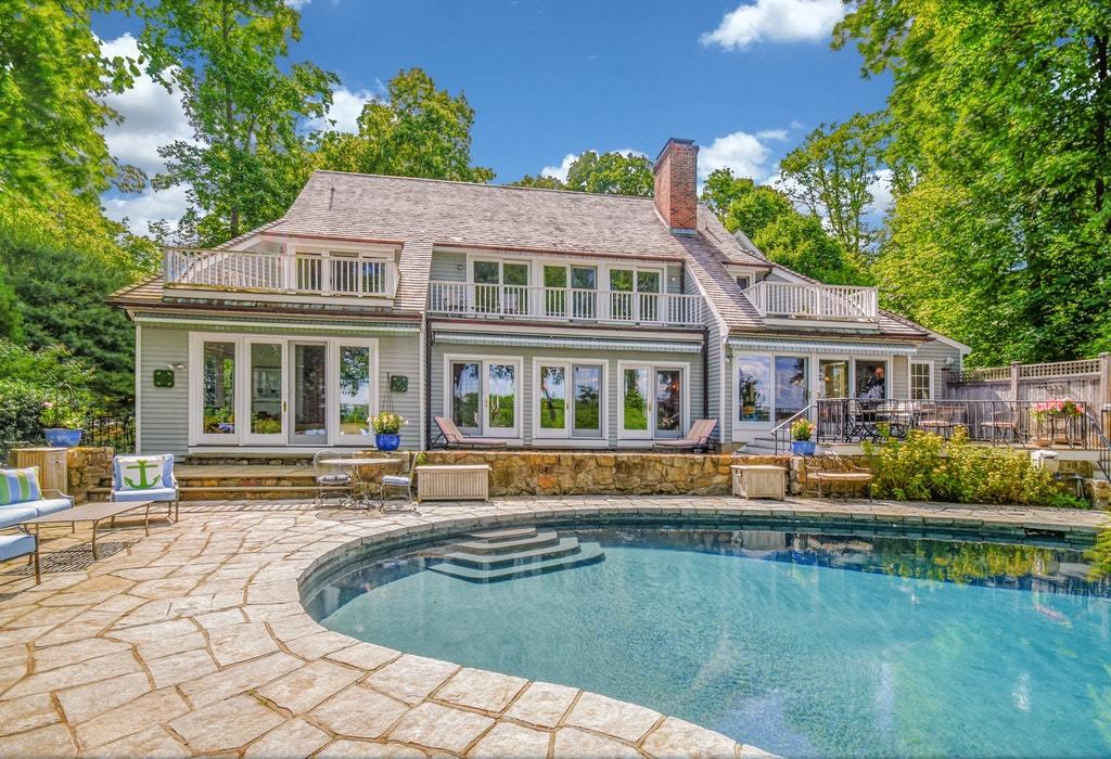 123 Long Neck Point Road Darien, CT 06820 - Photo 33 of 41 a front view of a house with swimming pool having outdoor seating