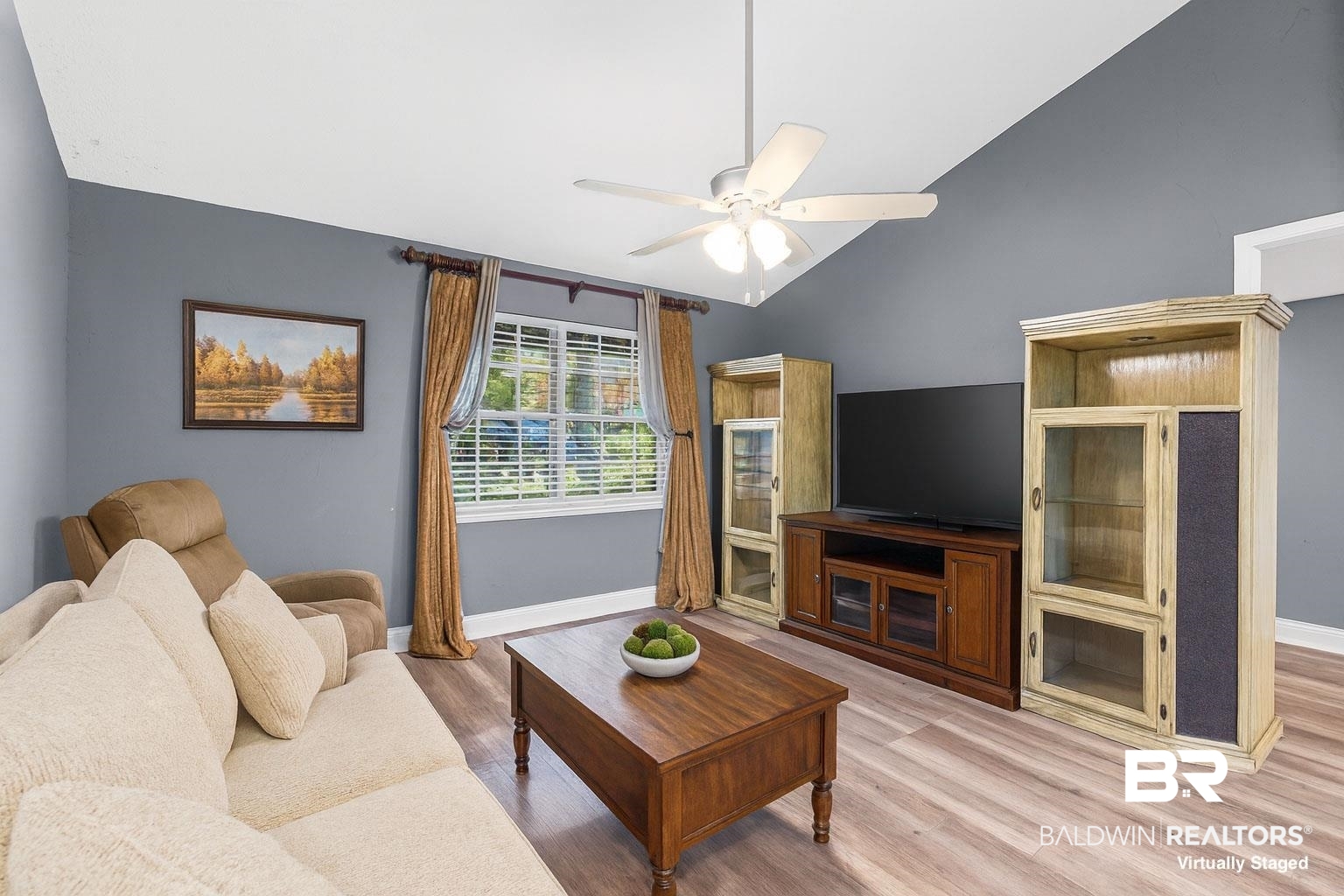 36 Ridgeview Drive Mobile, AL 36611 - Photo 7 of 20 Virtually staged living room with light wood finished floors, vaulted ceiling, and a ceiling fan