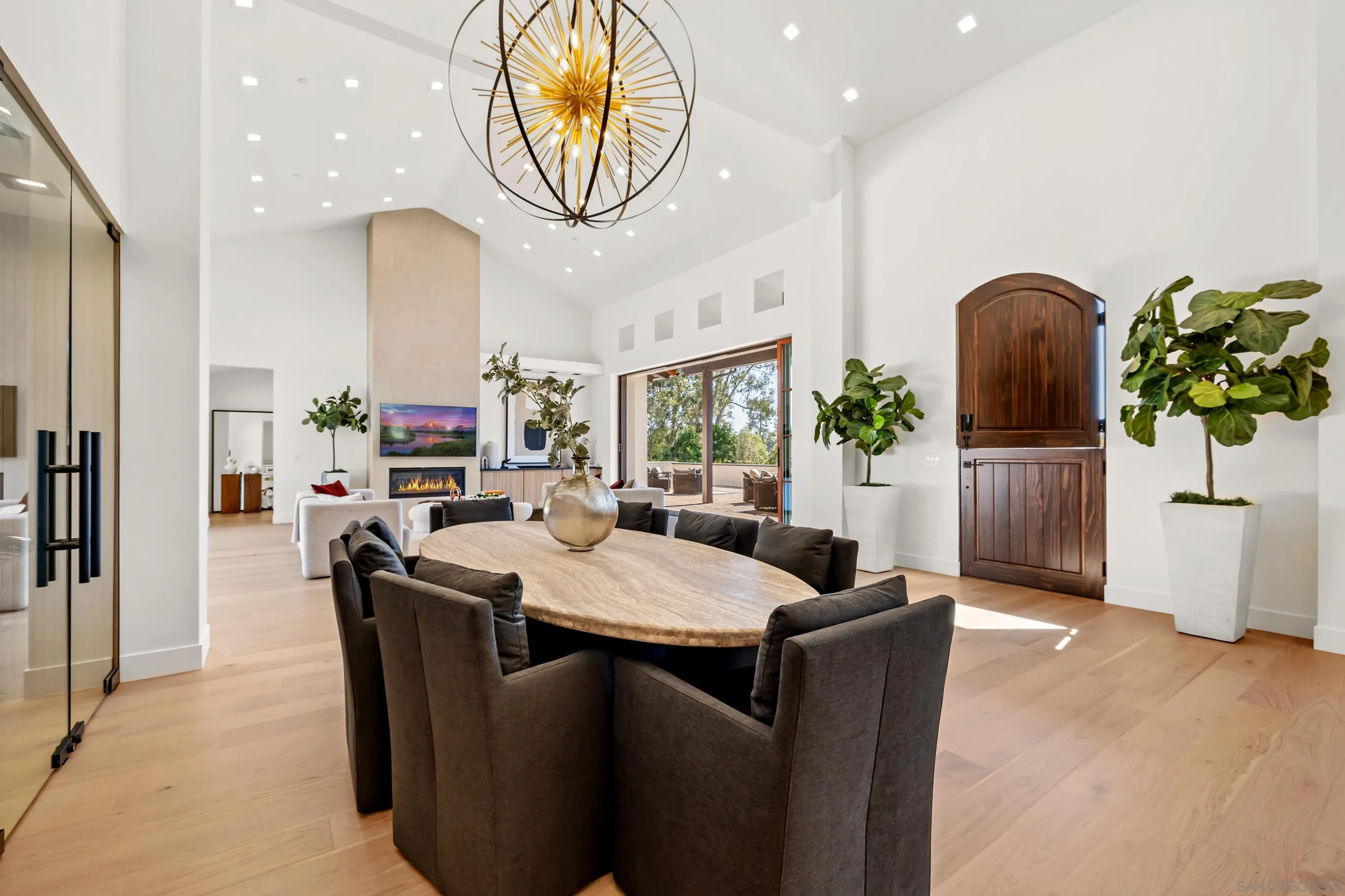 a dining room with kitchen island furniture a chandelier and kitchen view
