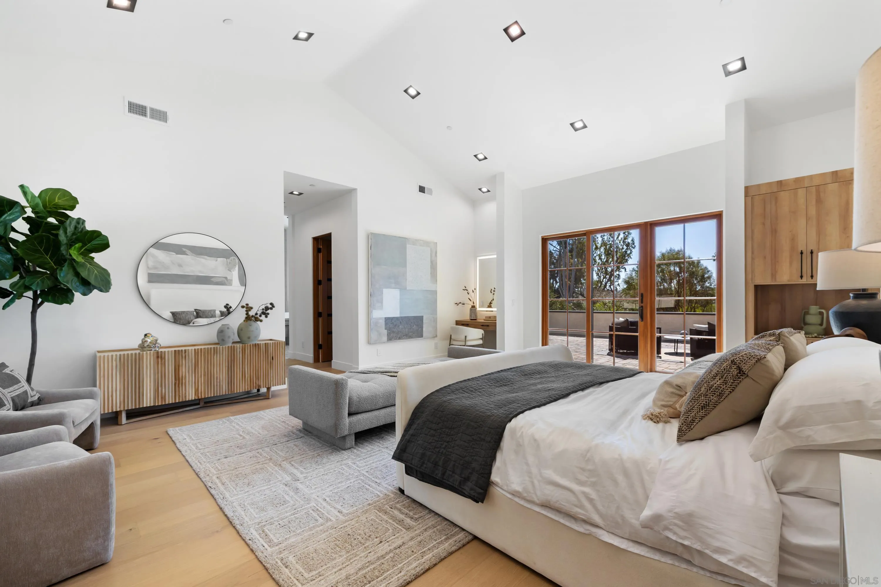 5758-60 Las Palomas Rancho Santa Fe, CA 92067 - Photo 49 of 64 a bedroom with a large bed and a chandelier