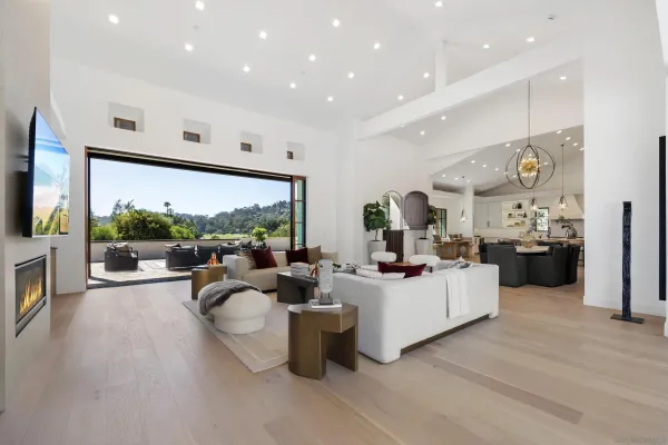 a living room with fireplace furniture and a large window