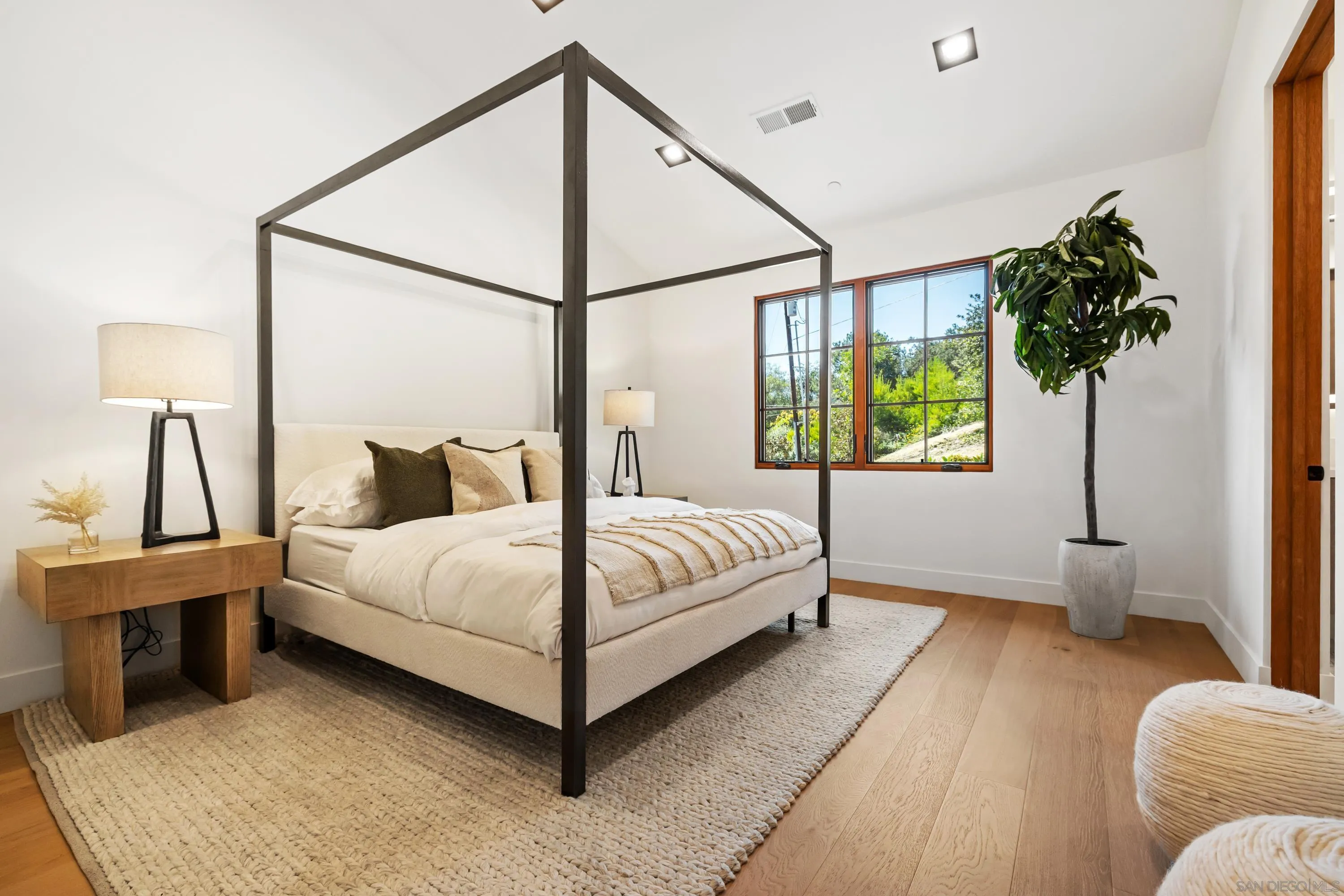 5758-60 Las Palomas Rancho Santa Fe, CA 92067 - Photo 54 of 64 a bedroom with a bed lamp and a large window