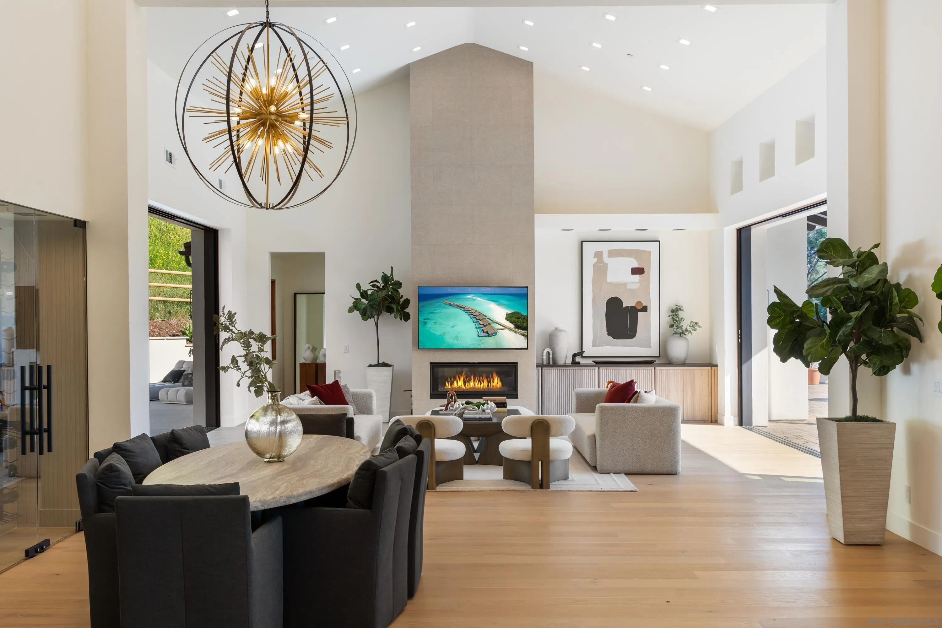 5758-60 Las Palomas Rancho Santa Fe, CA 92067 - Photo 9 of 64 a living room with furniture a chandelier and a wooden floor