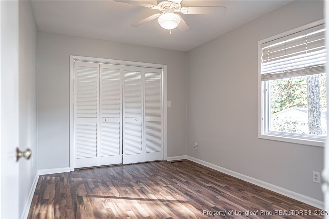 255 Foxcroft Road Whispering Pines, NC 28327 - Photo 16 of 31 a view of an empty room with wooden floor and window