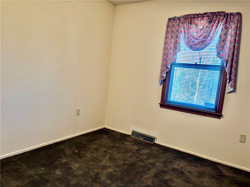 112 Ross Drive Starr, SC 29684 - Photo 11 of 23 This cozy bedroom features comfortable flooring and a bright window, creating a serene personal retreat.
