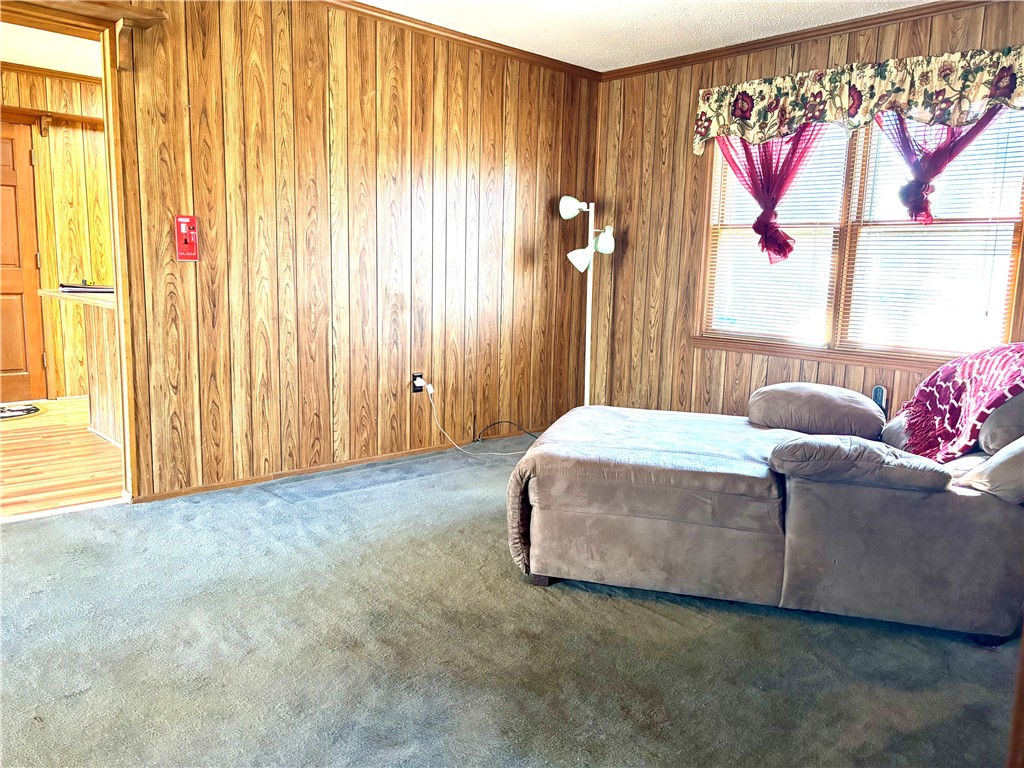 112 Ross Drive Starr, SC 29684 - Photo 19 of 23 This inviting room features warm wood paneling and ample natural light, creating a comfortable living space.