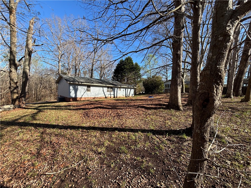 112 Ross Drive Starr, SC 29684 - Photo 20 of 23 This charming home is nestled among mature trees, offering a serene and private outdoor setting.