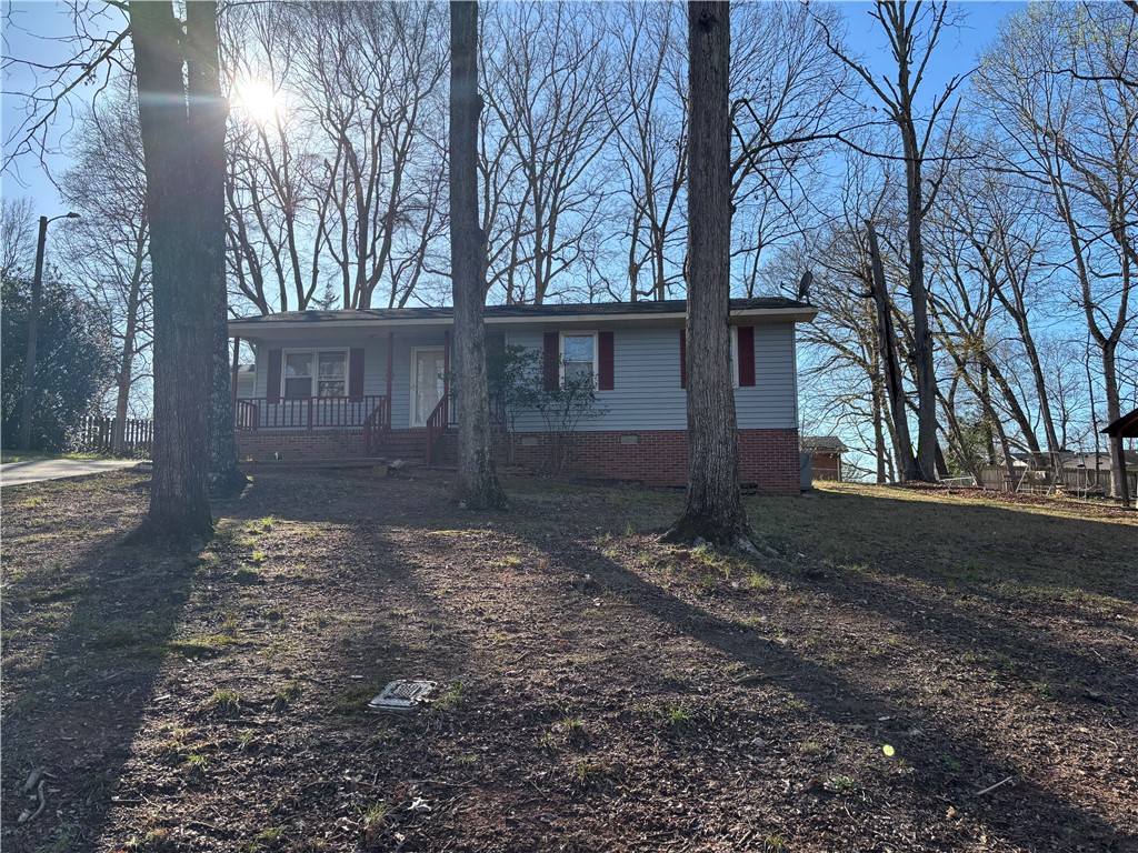 112 Ross Drive Starr, SC 29684 - Photo 2 of 23 This inviting home presents a welcoming facade nestled among mature trees.