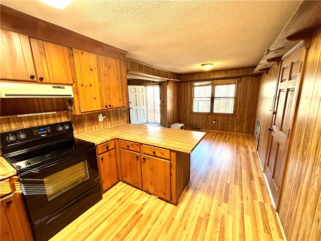 112 Ross Drive Starr, SC 29684 - Photo 6 of 23 This cozy kitchen features warm wood cabinetry and a functional layout.