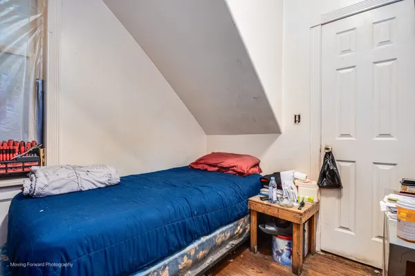 a bedroom with a bed and a window