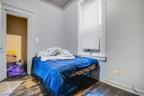 a bedroom with a bed and a window