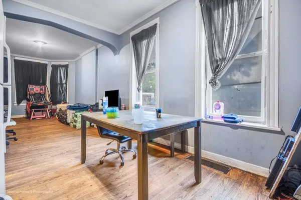 a room with stainless steel appliances kitchen island granite countertop furniture and a fireplace