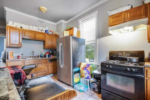 a kitchen with stainless steel appliances a stove a sink and a refrigerator