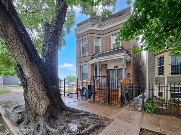 a view of a brick house with a large windows and large tree