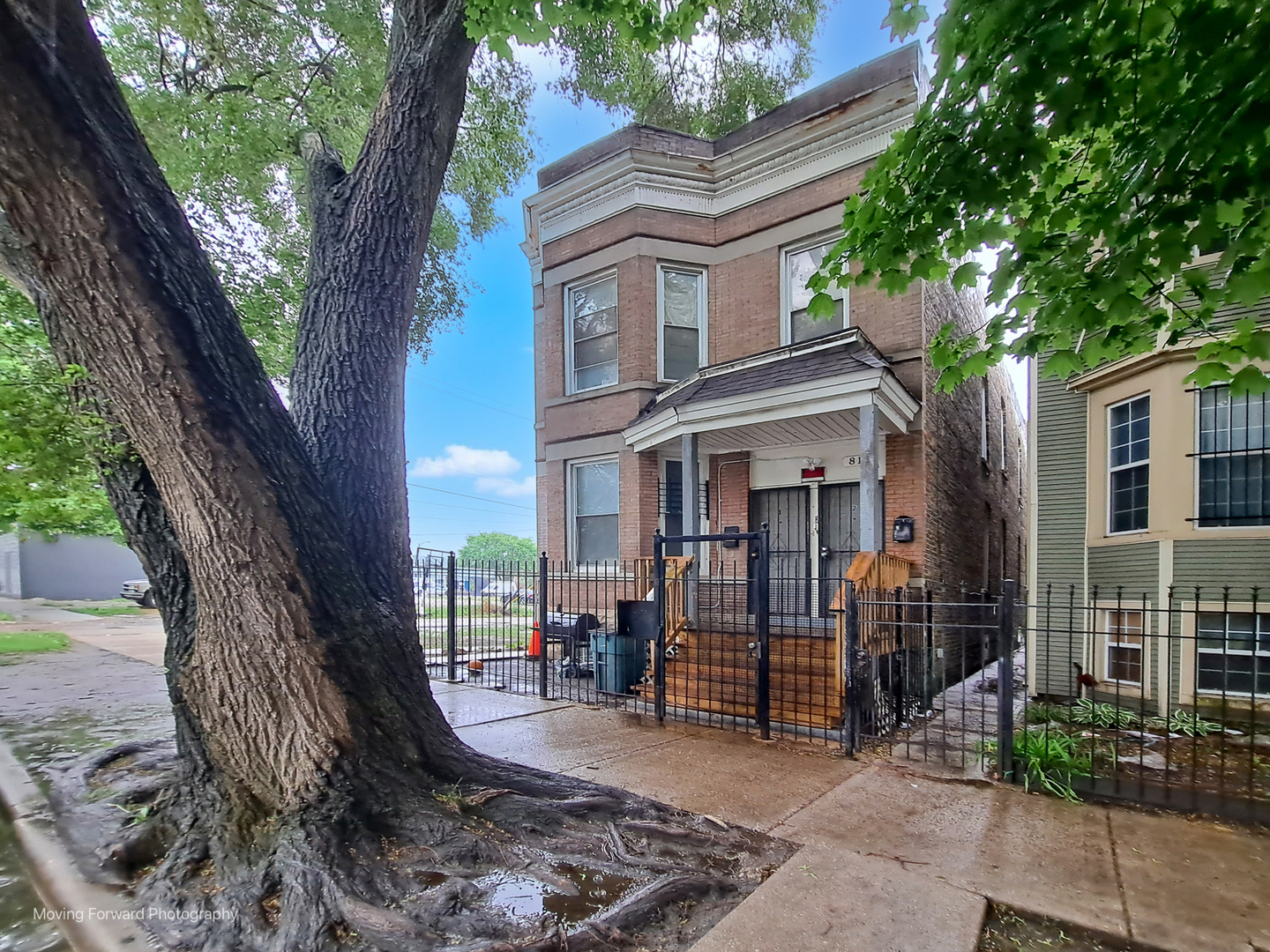 817 West 54th Street Chicago, IL 60609 - Photo 2 of 29 a view of a brick house with a large windows and large tree