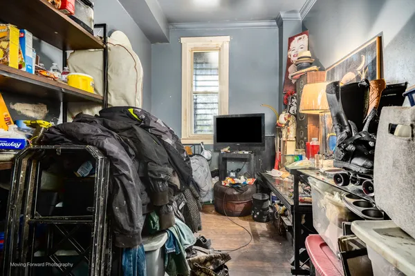 a view of walk in closet with clothes and shoes