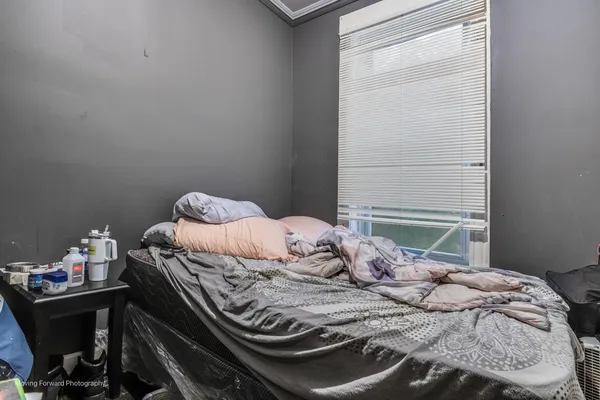 a bedroom with a bed and a window