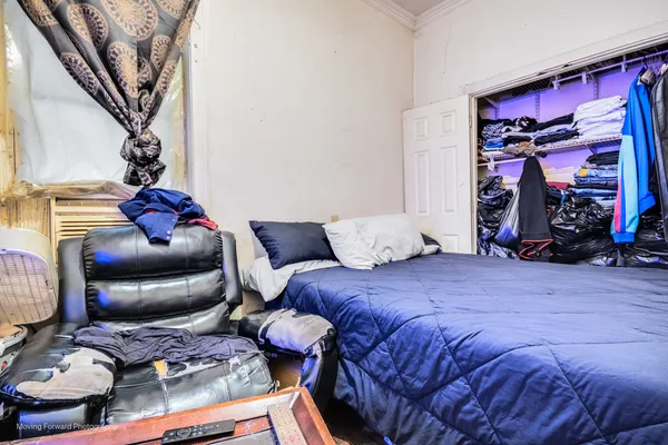 a bedroom with a bed and a couch