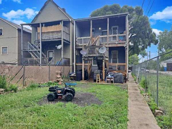 a view of a house with backyard sitting area and garden