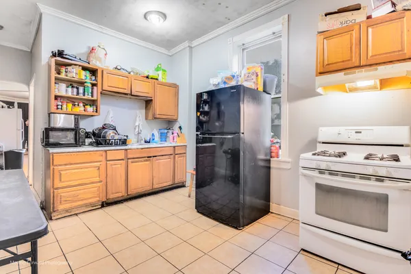 a kitchen with stainless steel appliances granite countertop a refrigerator and a stove