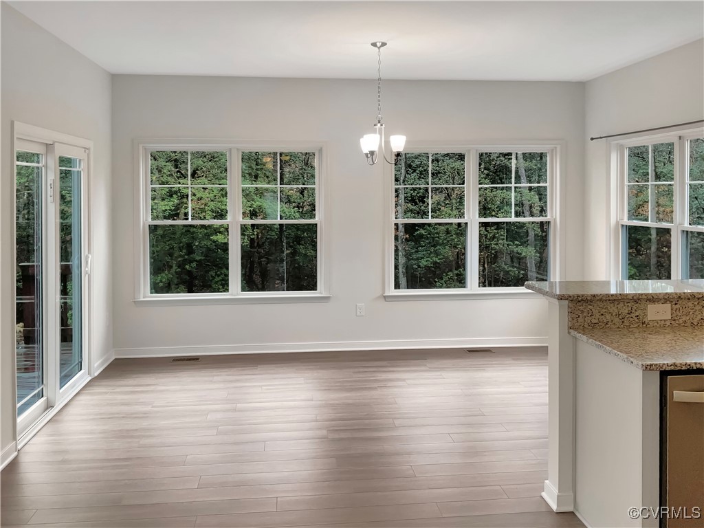 2206 White Oak Circle Aylett, VA 23009 - Photo 13 of 25 a view of an empty room with wooden floor and a window
