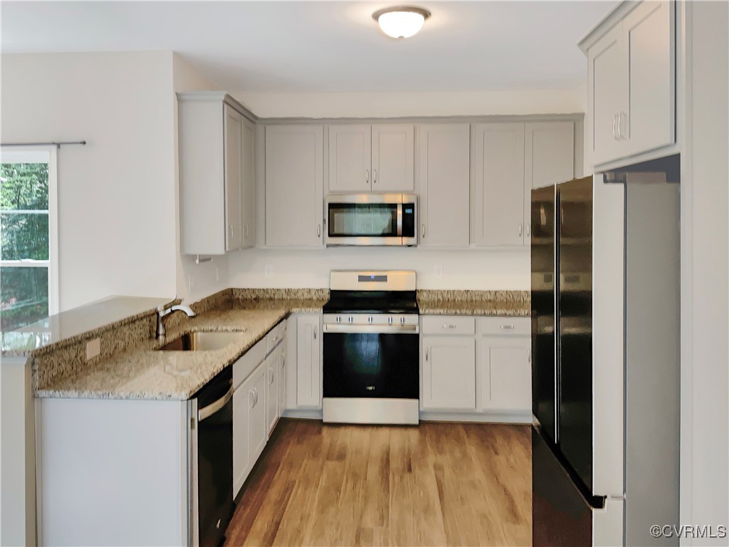 2206 White Oak Circle Aylett, VA 23009 - Photo 15 of 25 a kitchen with a sink stove and refrigerator
