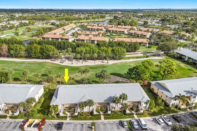 an aerial view of residential houses with outdoor space and swimming pool