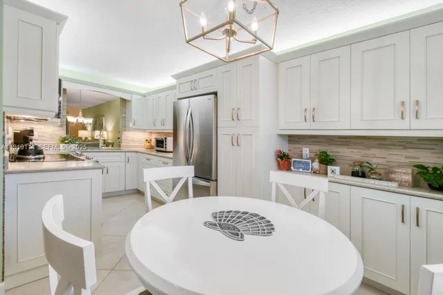 a kitchen with granite countertop a sink stainless steel appliances and cabinets