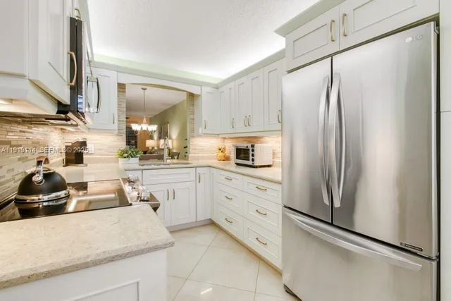 a view of a dining room with furniture a chandelier and wooden floor