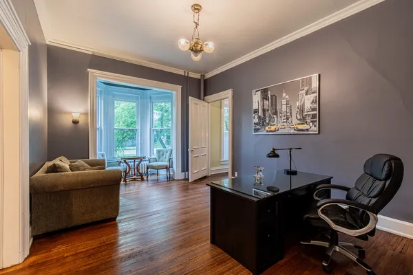 a living room with furniture chandelier and a window