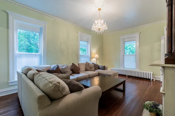 a living room with furniture a rug and a large window