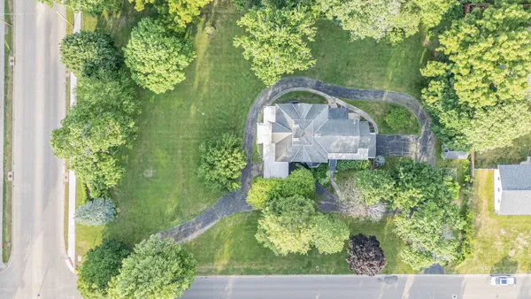 an aerial view of a house with a yard