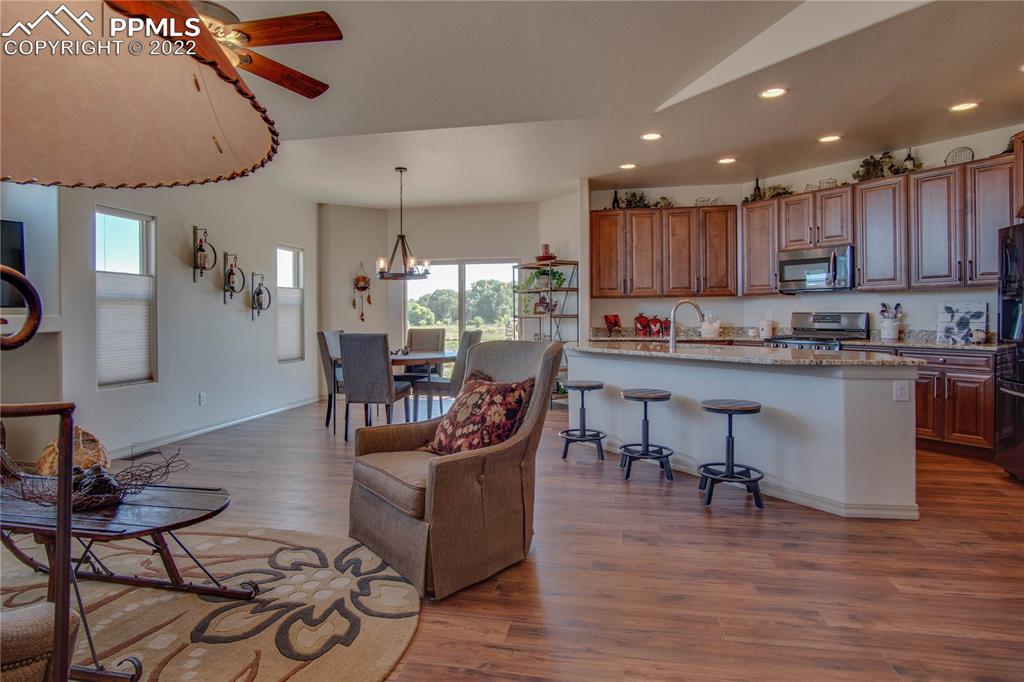 113 Rocchio Drive Florence, CO 81226 - Photo 2 of 34 a kitchen with a dining table chairs stove and cabinets