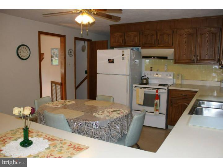 8 Tindall Road Robbinsville, NJ 08691 - Photo 14 of 21 a kitchen with stainless steel appliances kitchen island granite countertop a refrigerator and a stove