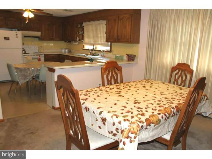 8 Tindall Road Robbinsville, NJ 08691 - Photo 5 of 21 a kitchen with a table chairs sink and cabinets