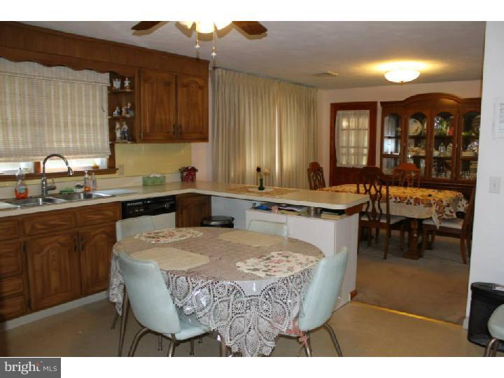 8 Tindall Road Robbinsville, NJ 08691 - Photo 7 of 21 a kitchen with a sink cabinets and dining table