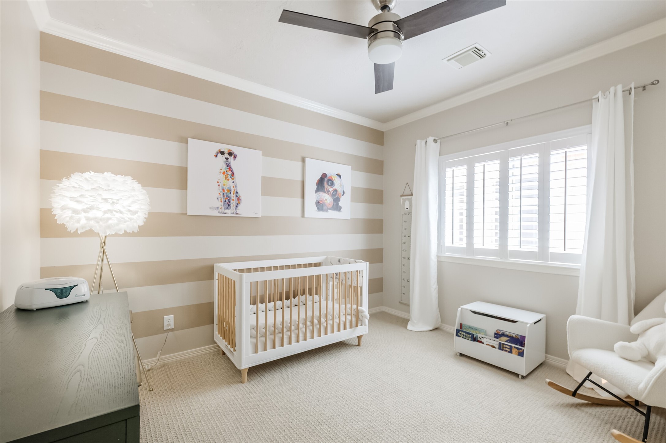 7515 Shady Villa Walk Houston, TX 77055 - Photo 13 of 23 Guest bedroom #1, located on the second floor, features a ceiling fan, crown molding, plantation shutters, and a walk-in closet. Note: Drapes are excluded.