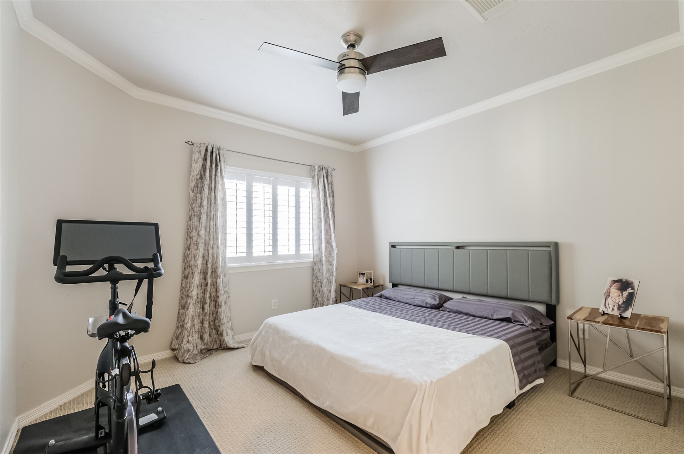 7515 Shady Villa Walk Houston, TX 77055 - Photo 14 of 23 Guest bedroom #2, located on the second floor, features a ceiling fan, crown molding, plantation shutters, and a double sliding door wall closet. Note: Drapes are excluded.