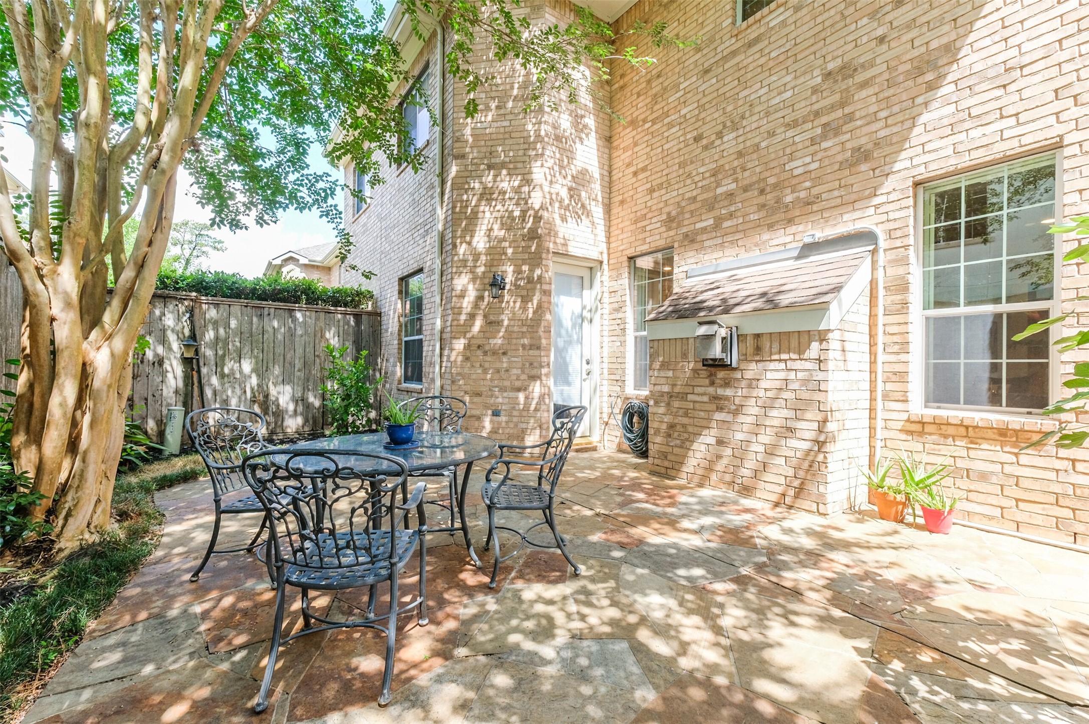 7515 Shady Villa Walk Houston, TX 77055 - Photo 19 of 23 Spacious back patio is located just off of the kitchen. Features a stone floor for easy maintenance. Fully fenced-in. Lots of room for outdoor entertaining and for dining al fresco.