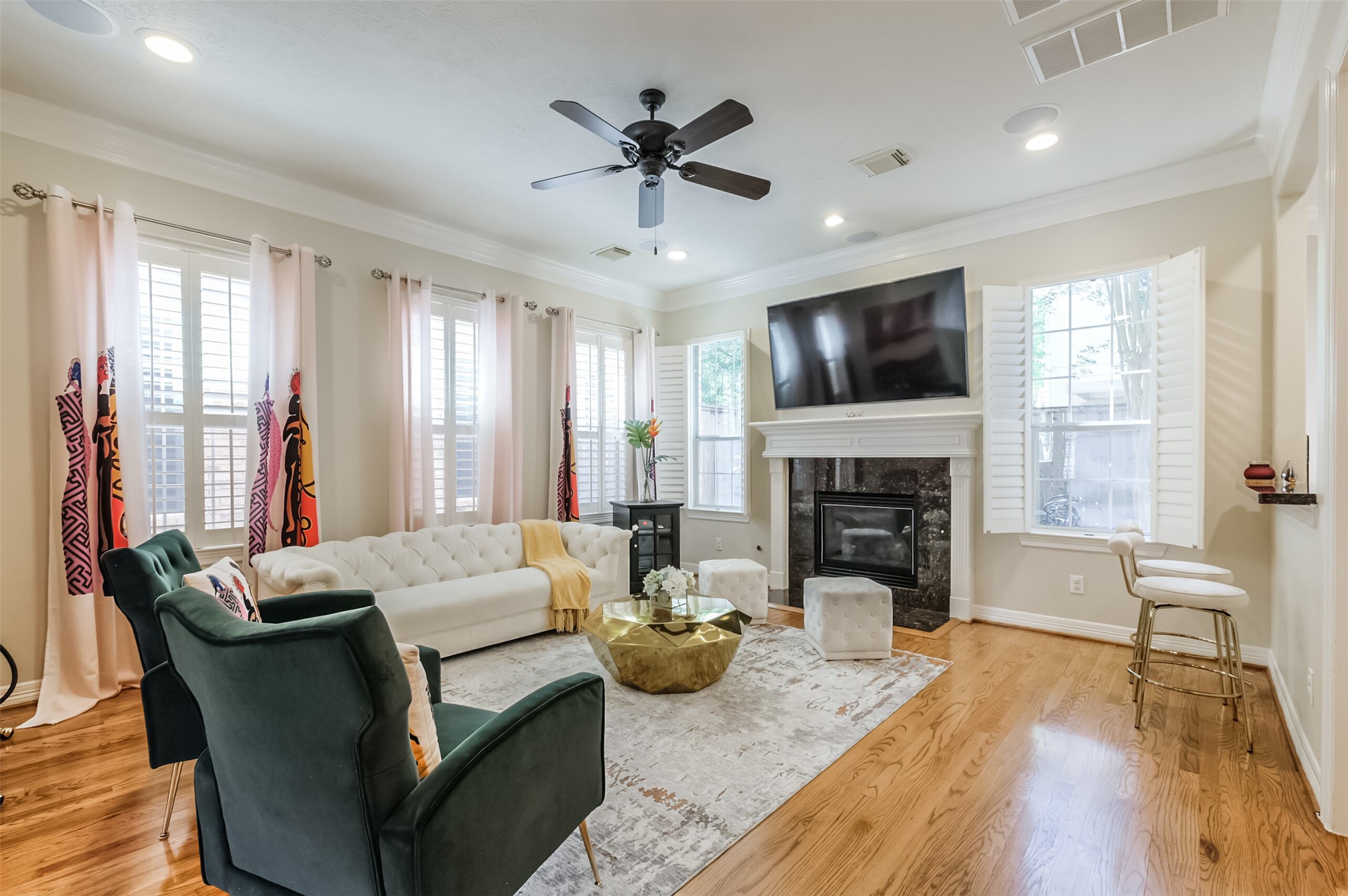 7515 Shady Villa Walk Houston, TX 77055 - Photo 4 of 23 As soon as you enter the home you are greeted by 10 foot tall ceilings and hardwood floors throughout the first floor of the home. Fabulous light filled living room features a gas log fireplace with granite surround and detailed millwork mantle. Other highlights include hardwood floors, recessed can lighting, ceiling speakers, windows with plantation shutters, ceiling fan and double crown molding. Note: Drapes are excluded.