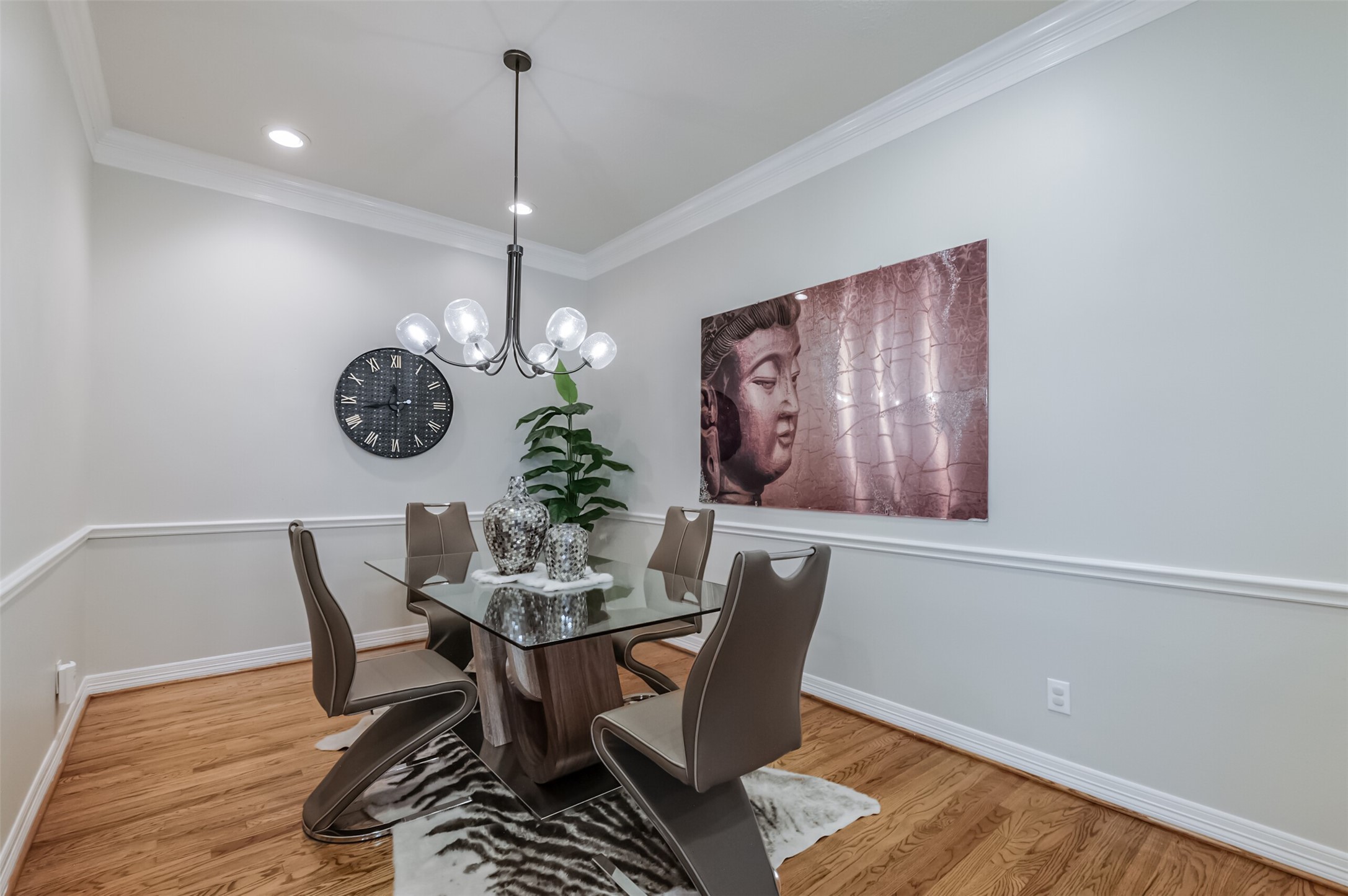 7515 Shady Villa Walk Houston, TX 77055 - Photo 5 of 23 Sophisticated dining room with a decorative light fixture, chair rail millwork detail, double crown molding and recessed can lighting.