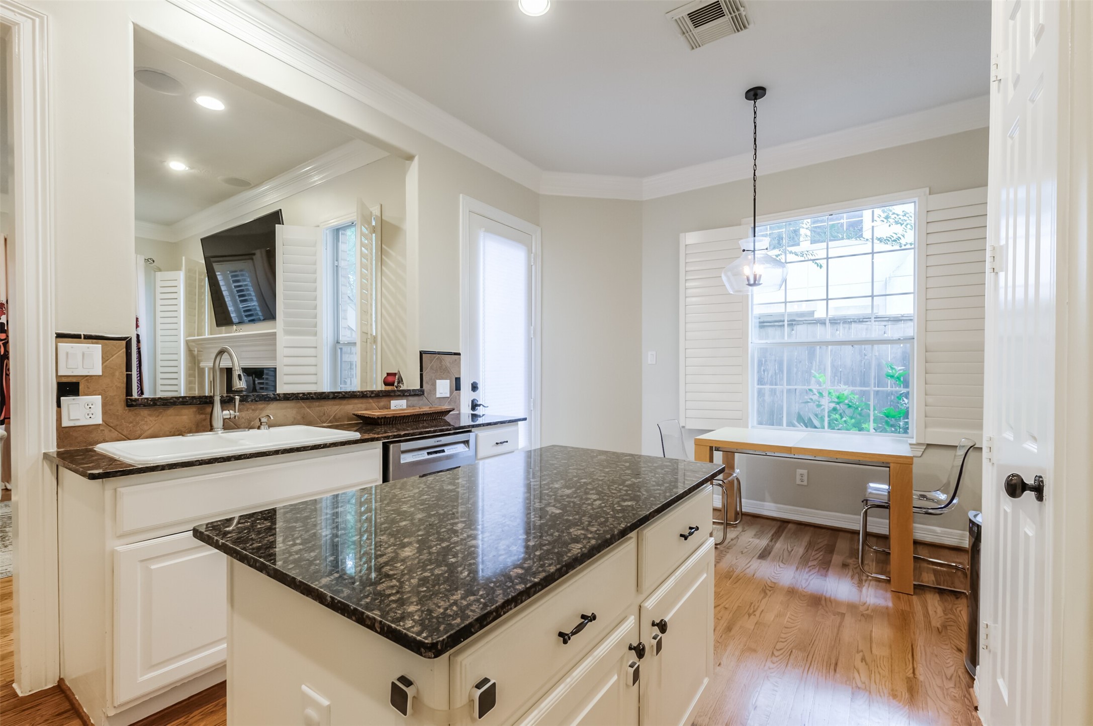 7515 Shady Villa Walk Houston, TX 77055 - Photo 7 of 23 Another view of the kitchen featuring tons of storage cabinets, island, granite countertops, under cabinet lighting, double crown molding, can lights and pantry closet on the right. Notice the breakfast space.