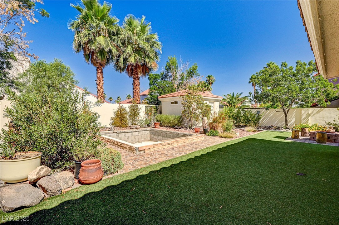 33 Reyburn Drive Henderson, NV 89074 - Photo 36 of 41 Landscaped backyard with an area reserved for a spa, conversation pit, or a play area.