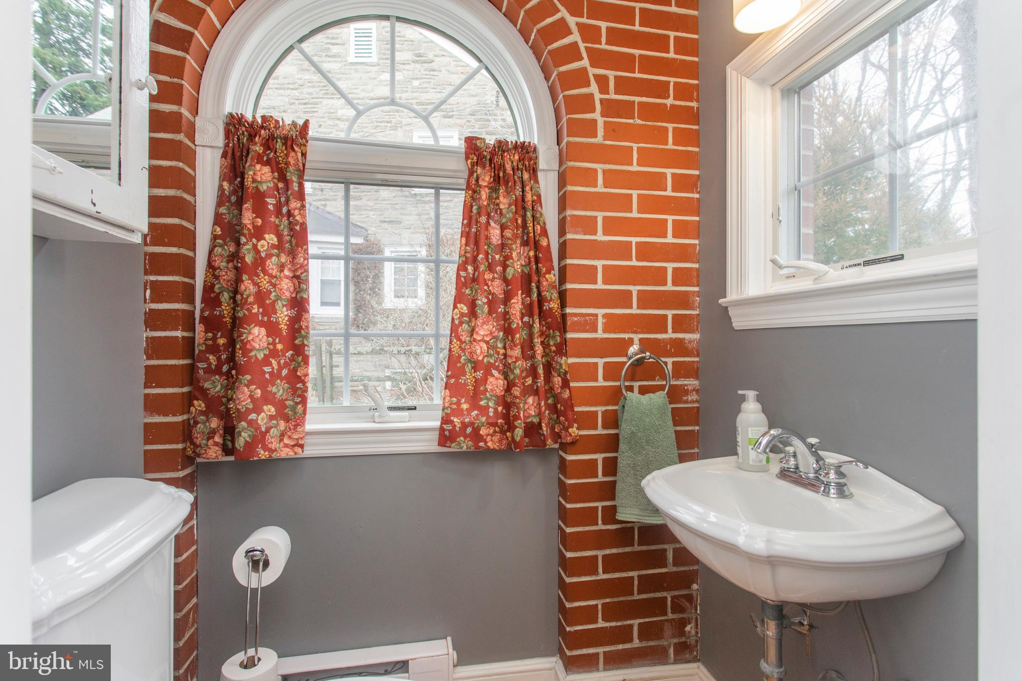 233 Barker Road Wyncote, PA 19095 - Photo 22 of 61 Powder room with beautiful window & brick detail
