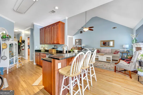 a living room filled with furniture and a wooden floor