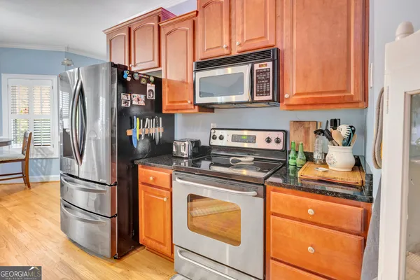 a kitchen with stainless steel appliances granite countertop a refrigerator stove and sink