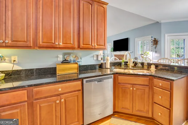 a kitchen with stainless steel appliances granite countertop a sink stove and cabinets
