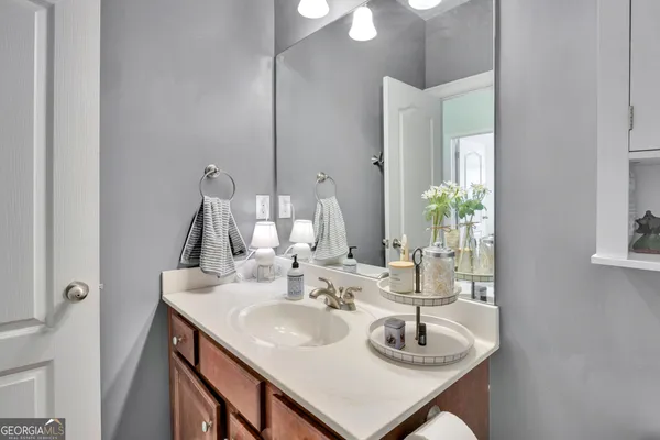 a bathroom with a sink a mirror and vanity