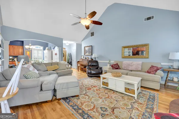 a living room with furniture and a chandelier